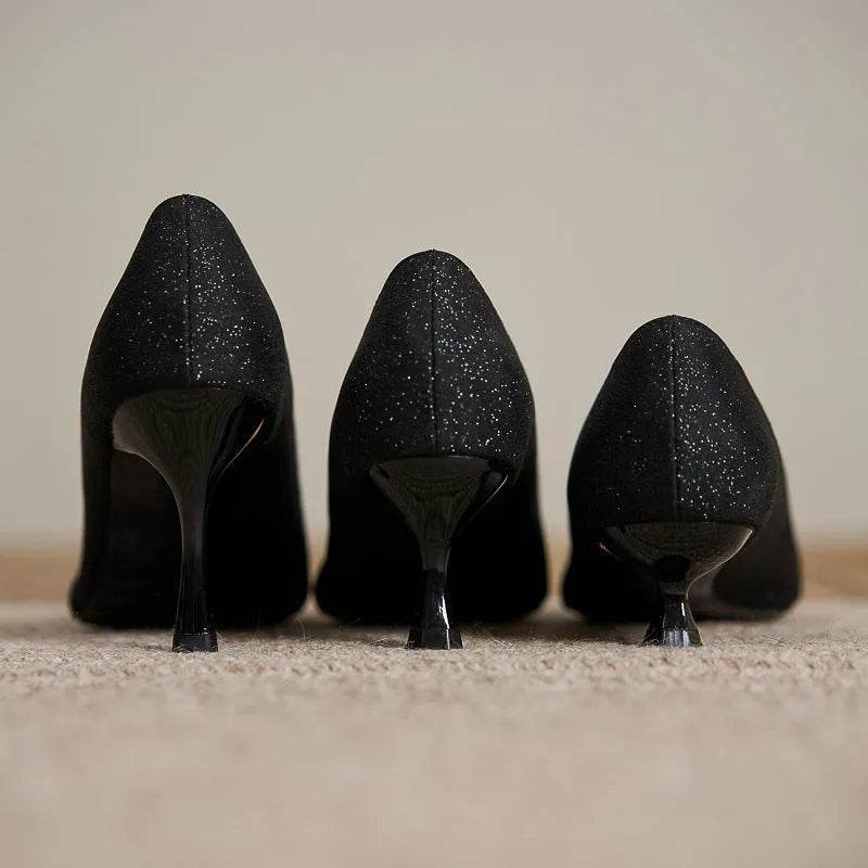 Black sequined women's high heel pumps with a 7cm stiletto heel and low upper.