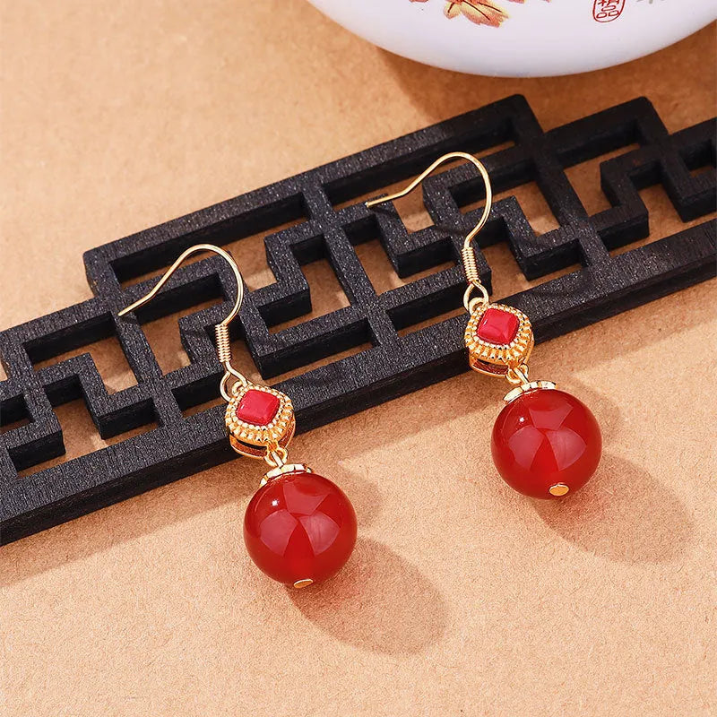 Geometric drop earrings with round Southern Red Agate beads and silver jasper inlay on an electroplated copper base.
