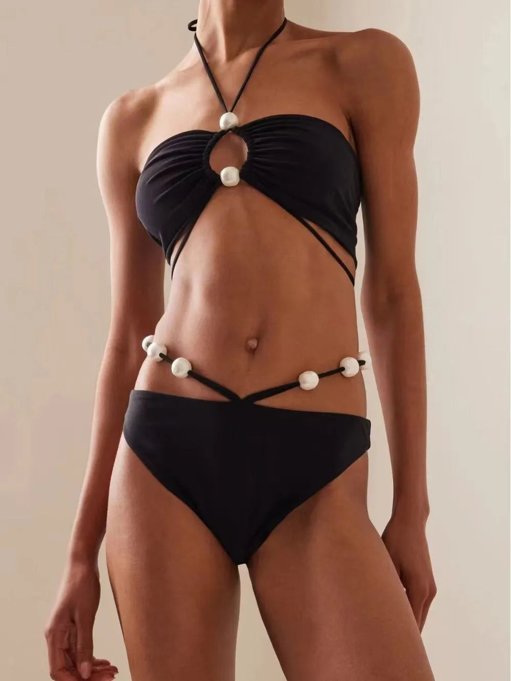Women's black split bikini swimsuit with lace-up detailing and briefs style design