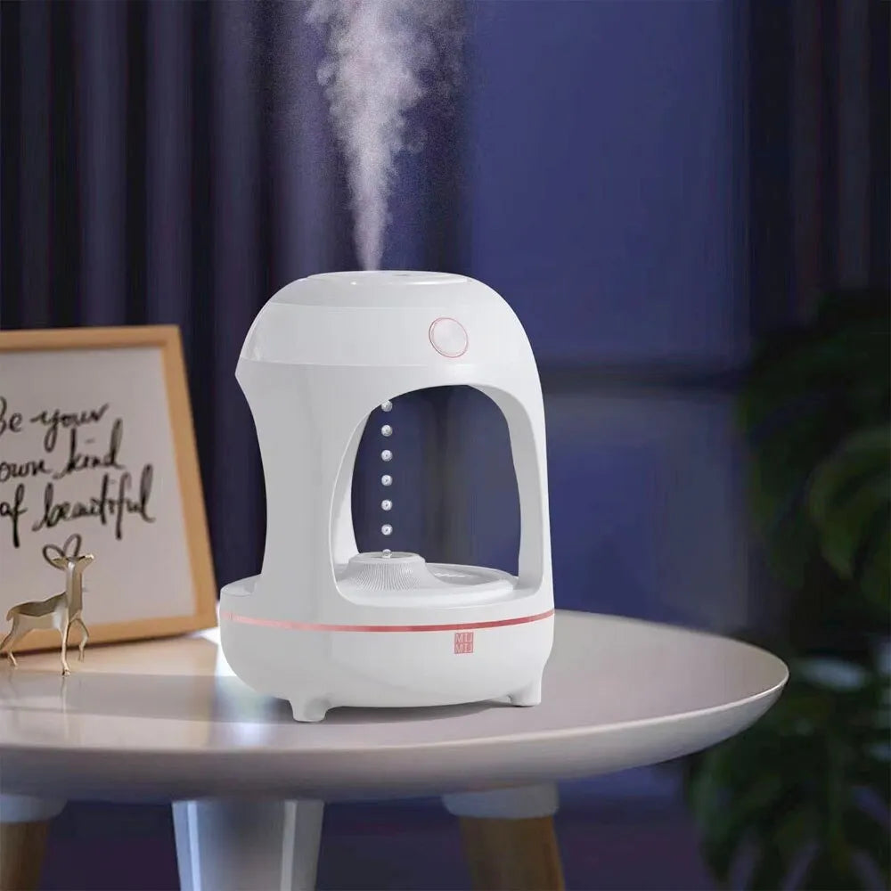Rose gold and white levitating water drops humidifier with LED light on desk