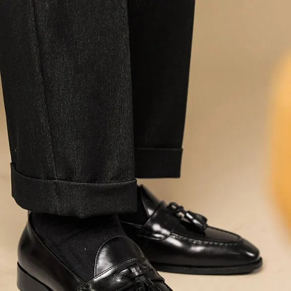 Men's black polished leather tassel loafers with rubber soles for business casual wear
