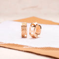 Rose gold women's earrings with three hollow heart shapes in circular arrangement