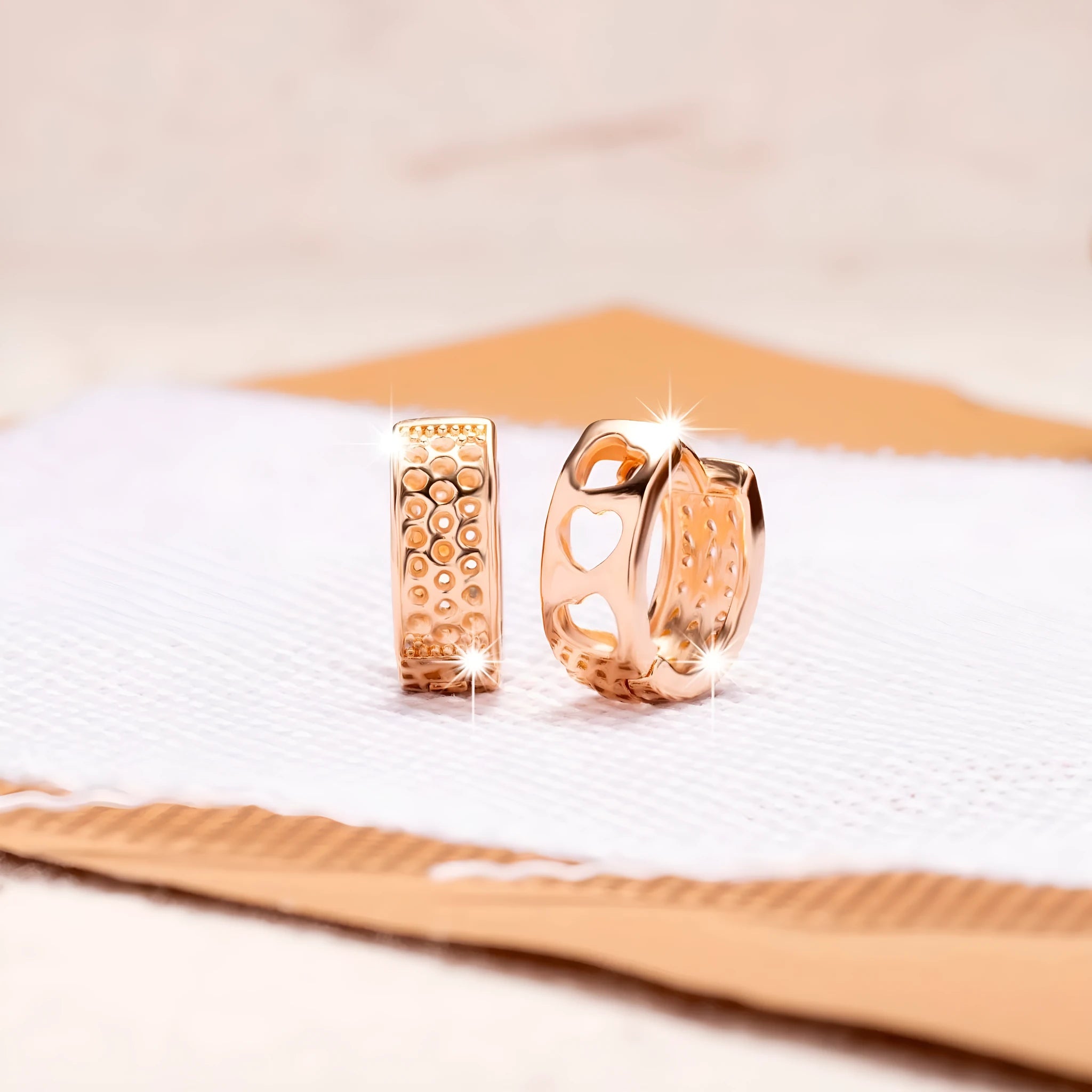 Rose gold women's earrings with three hollow heart shapes in circular arrangement
