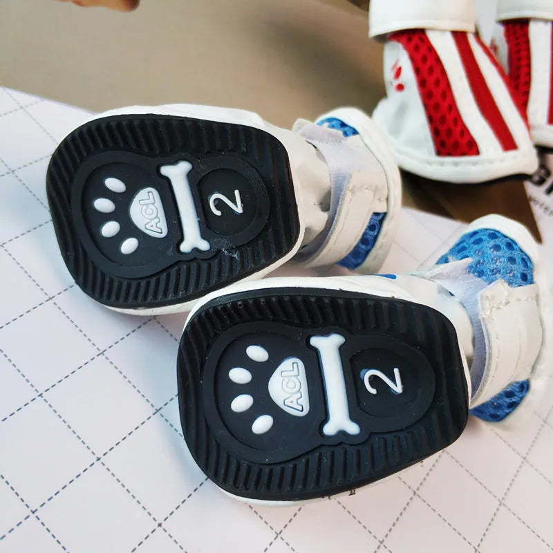 Set of four blue cloth dog shoes with zippers and non-slip soles for small to medium dogs.