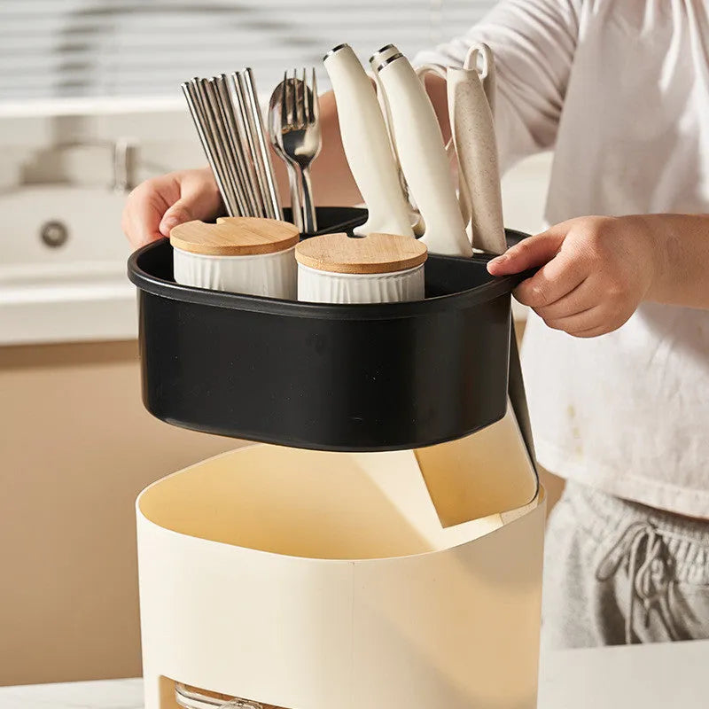 White rotating kitchen storage bucket with an integrated four-section spice box for cutlery and seasoning organisation.