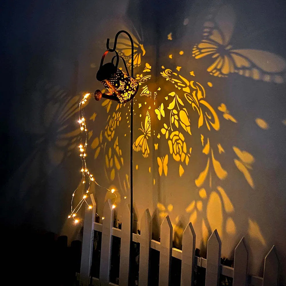 Solar-powered iron garden lamp with a tapered butterfly design emitting warm white LED light.