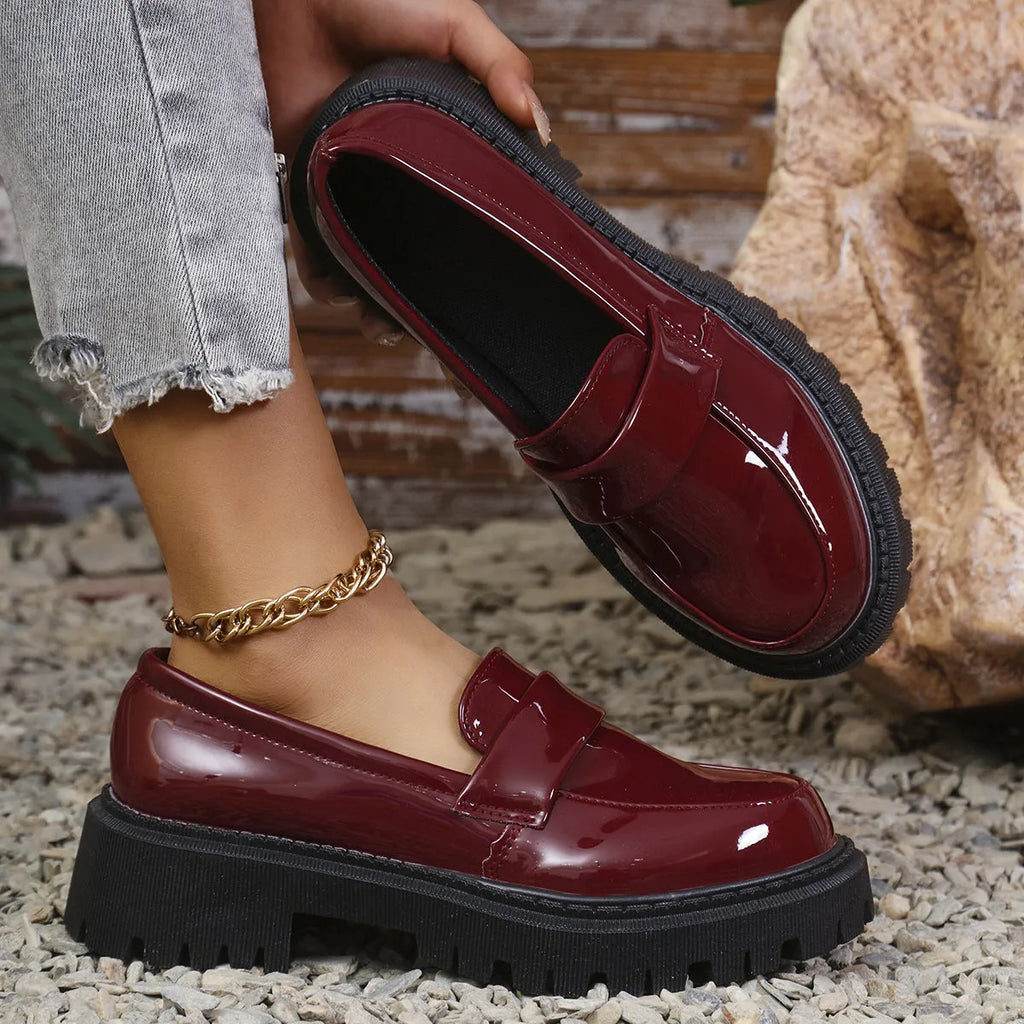 Black plus size women's loafers with a chunky platform heel and slip-on design.