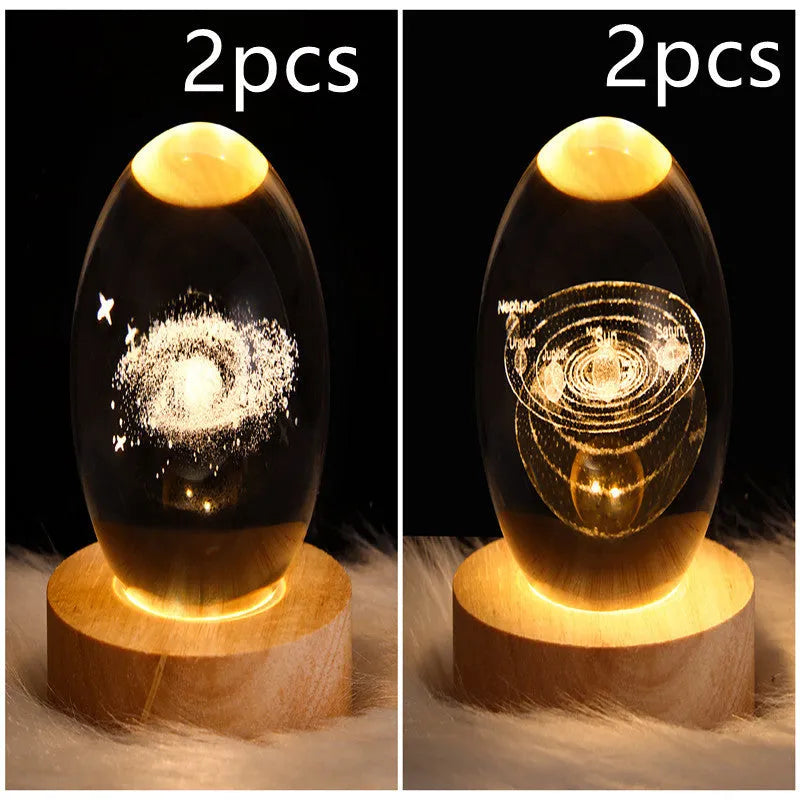 LED galaxy crystal ball night light with 3D planet designs on a table
