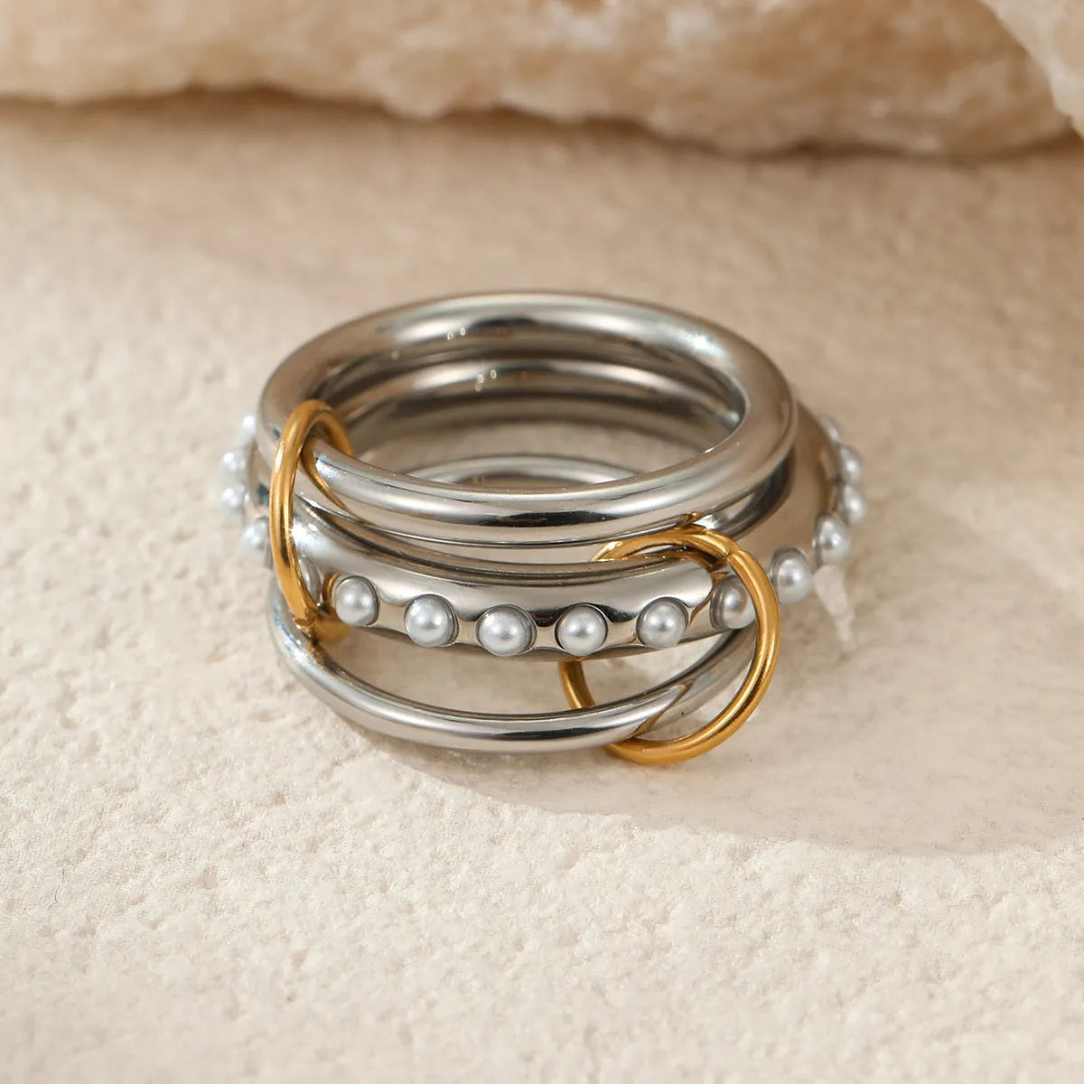 Three gold-plated geometric stacking rings with adjustable free size on hand
