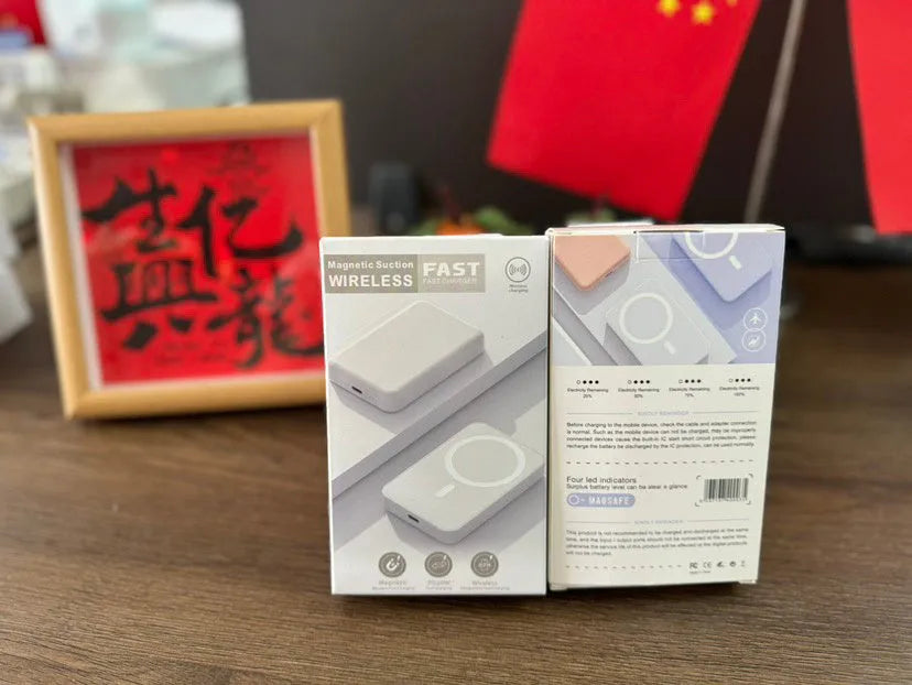 White foot-shaped portable power bank with magnetic wireless charger on a table.