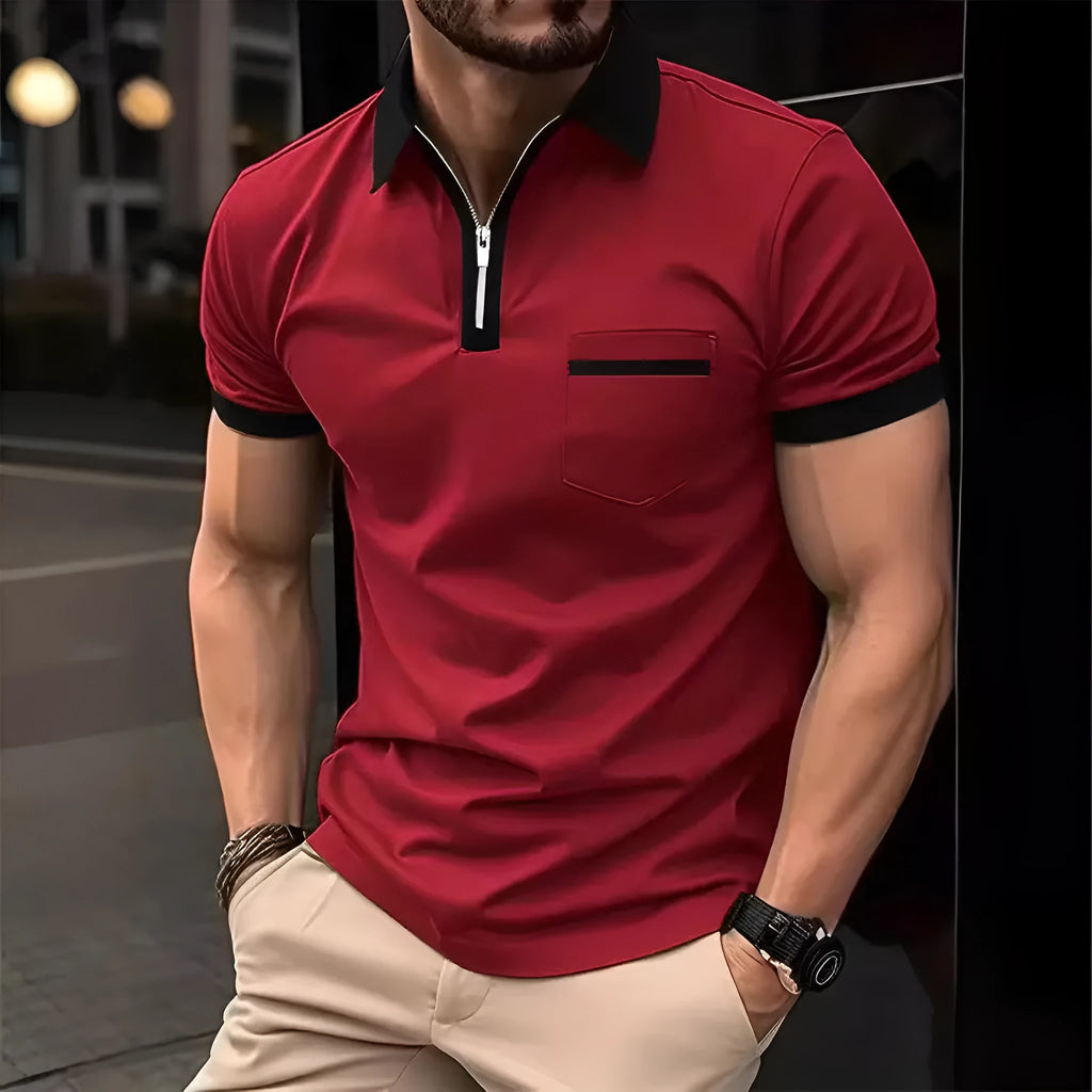 Man wearing a loose-fit short sleeve casual shirt with a chest pocket and zipper detail.