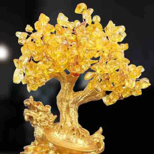 Citrine coloured resin turtle money tree Chinese style ornament on display.