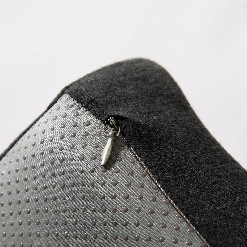 Black memory foam office chair cushion for waist support, shown on a desk chair.