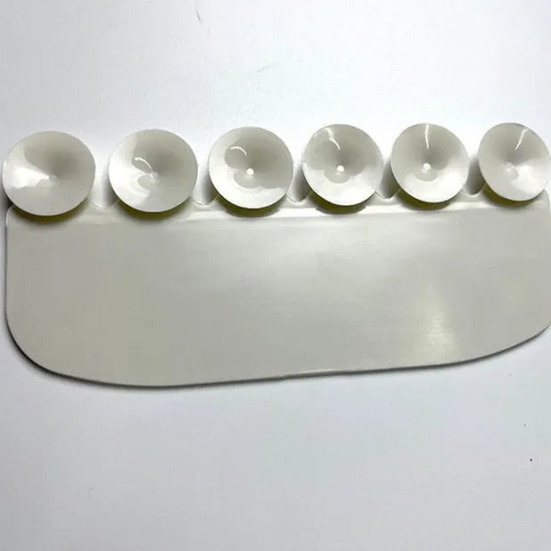 White plastic urine blocking board for toilet training placement on standard toilet bowl