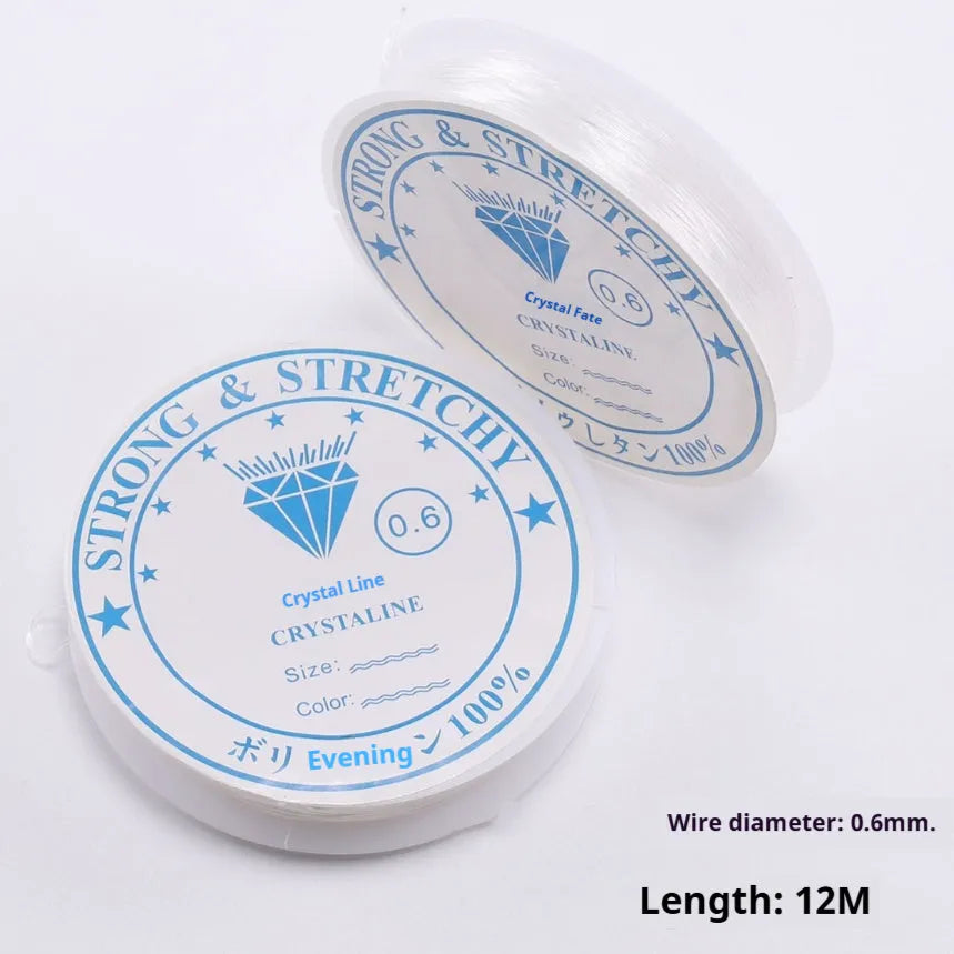 Reel of transparent white elastic fishing line thread for DIY crafting on a white background.