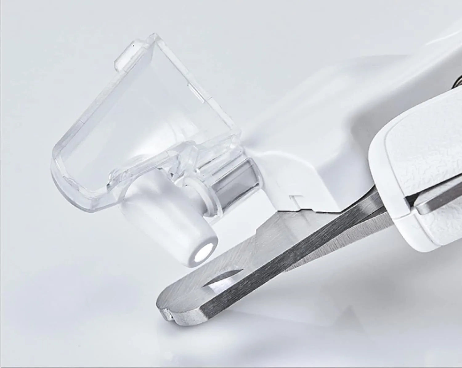 White LED pet nail clippers with a transparent guard open, showing the triangular blade and integrated nail file.