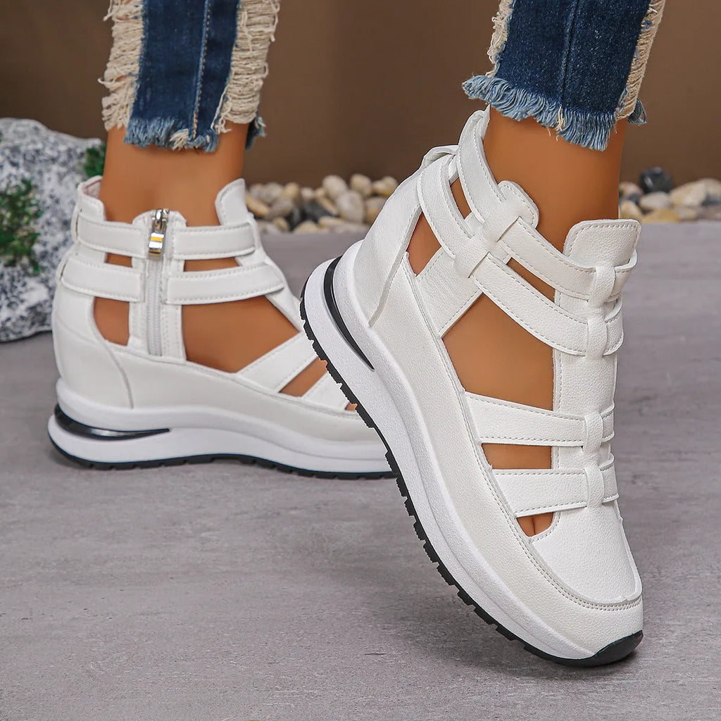 Black women's close-toed hollow-out platform sandals with Velcro strap on a white background