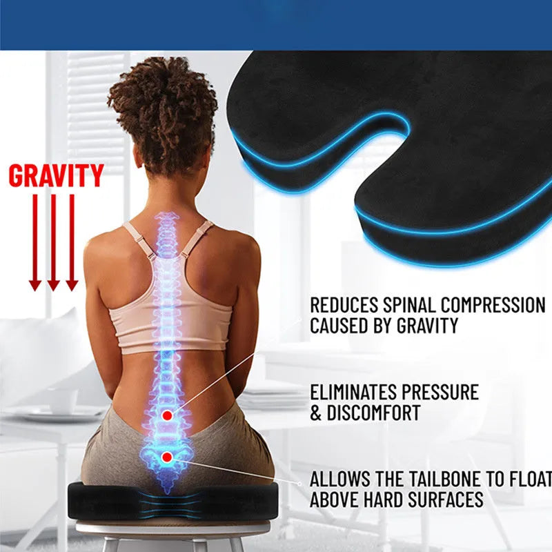 Black U-shaped memory foam seat cushion for office chairs, shown on a wooden seat.