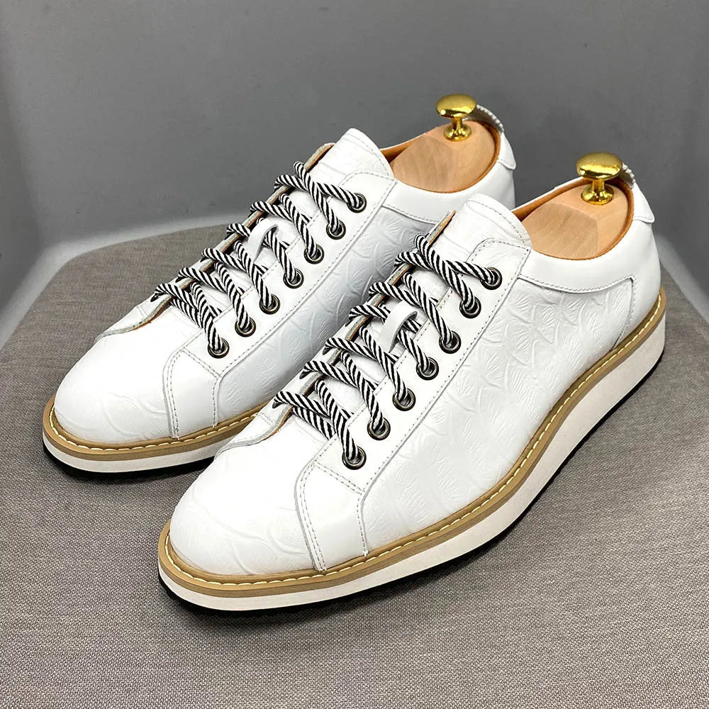 Men's low-top handmade shoes with an embossed pattern and front tie laces.