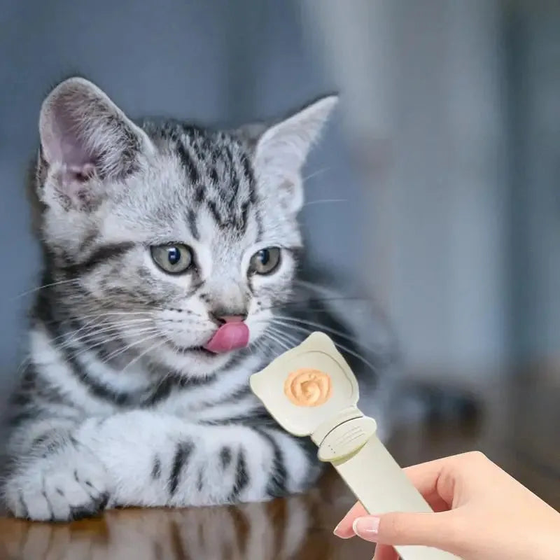 Cat Treat Spoon in green, orange, and white, measuring 27 x 6.5 cm, designed for scooping and serving cat strips