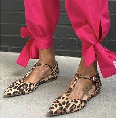 Women's black leopard print pointed toe pumps with a chunky low block heel and cross ankle straps.