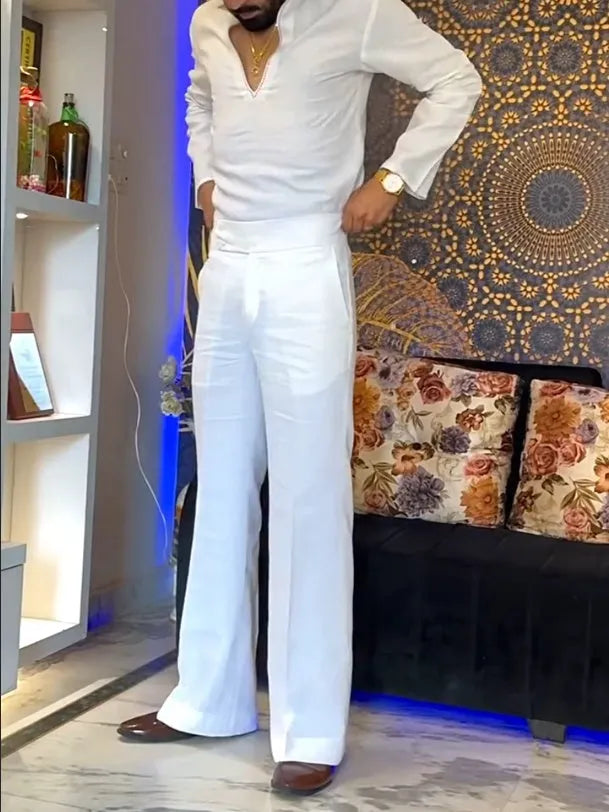 White women's three-piece outfit comprising a V-neck shirt, sleeveless vest, and full-length trousers.