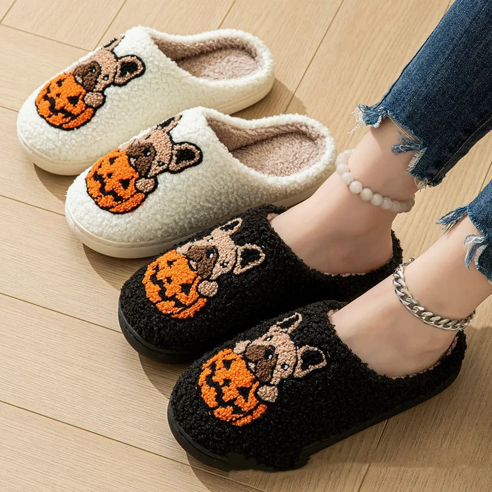 Black and white Halloween plush slippers with pumpkin pattern and non-slip rubber soles.