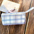 Square double-layer canvas stationery bag in a red stripe grid pattern.