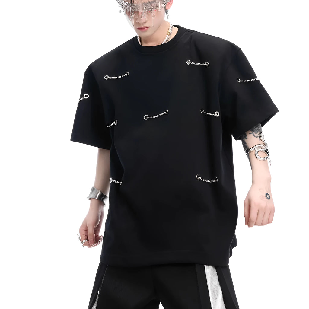 Black T-shirt with padded shoulders and metal chain detail on short sleeves
