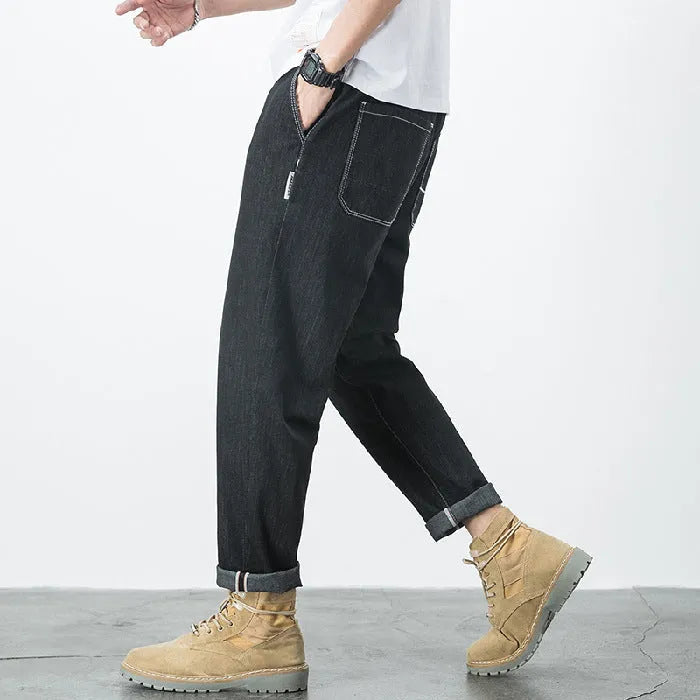 Men's loose plus size elastic waist jeans in blue cotton denim with mid waist straight leg fit