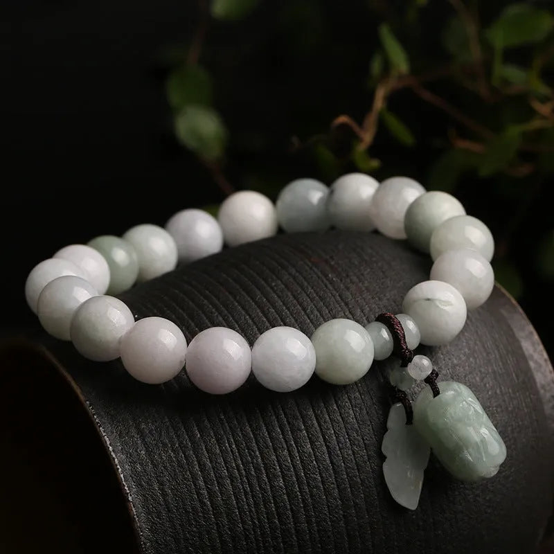 Emerald green jade hanging bracelet with Maitreya Buddha charm and geometric shapes