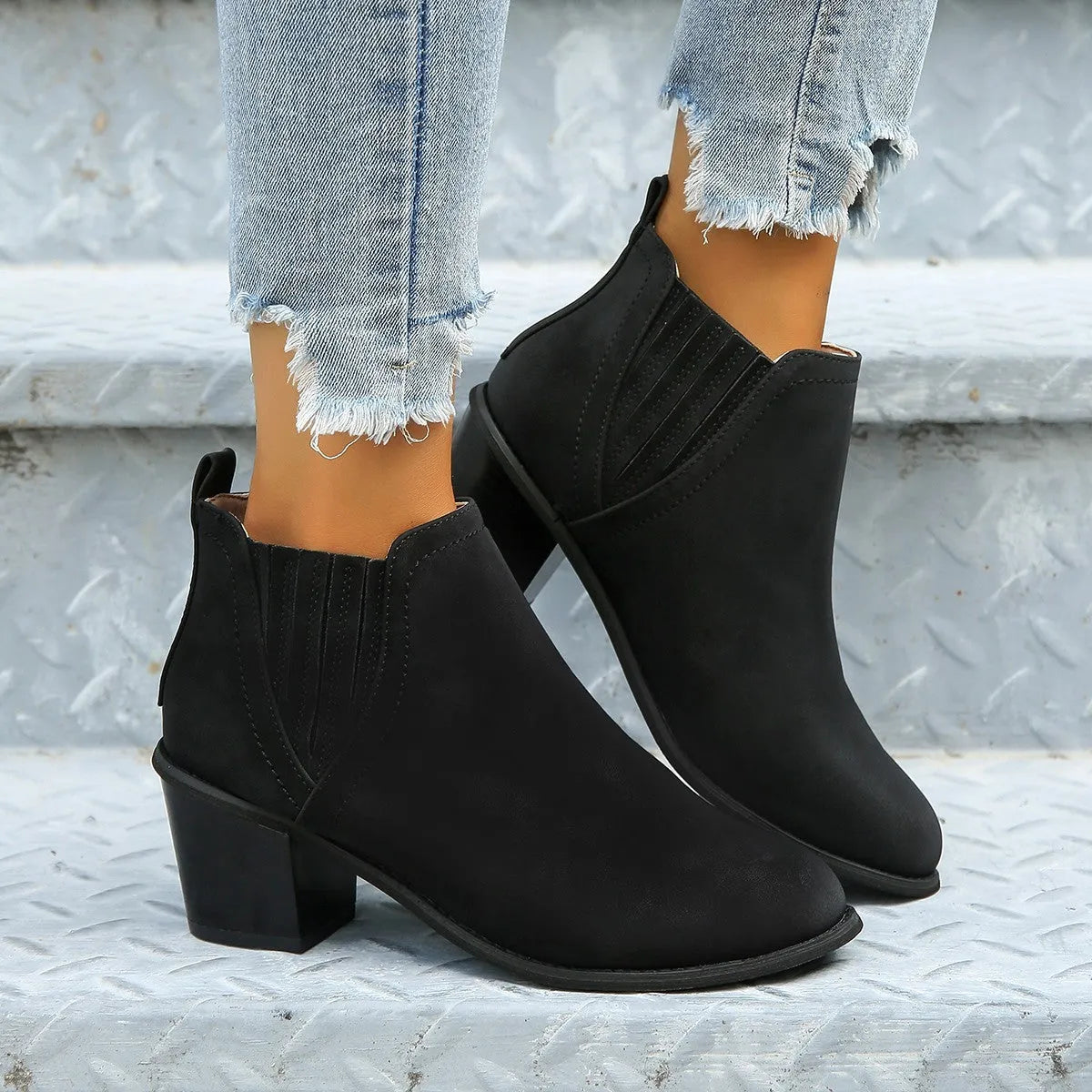 Black women's ankle boot with pointed toe and thick square low heel, slip-on design