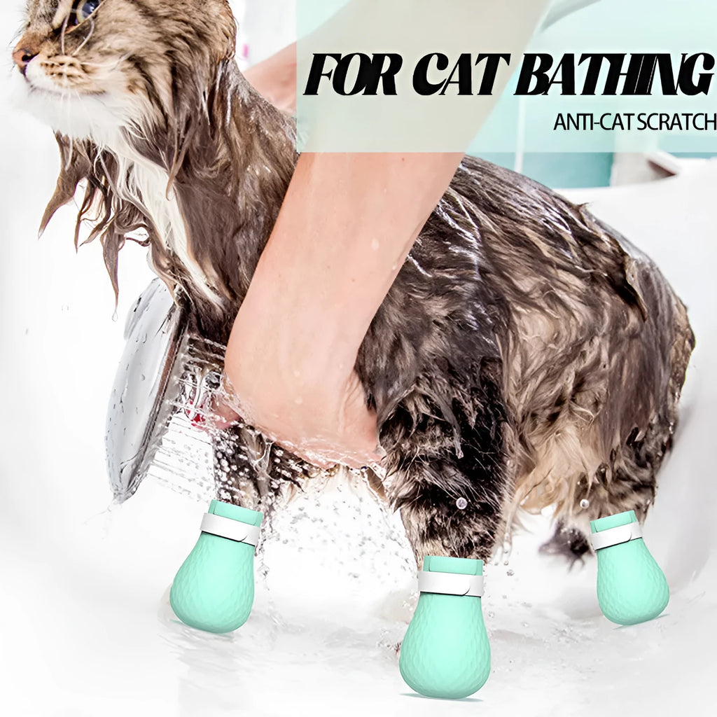 Four green silicone cat anti-scratch foot covers for pet handling protection