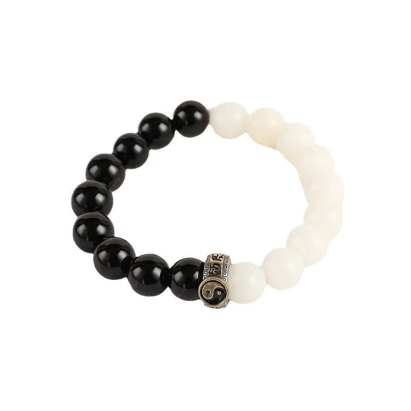 Black obsidian Taiji bracelet with white woven yin-yang symbol and mantra.