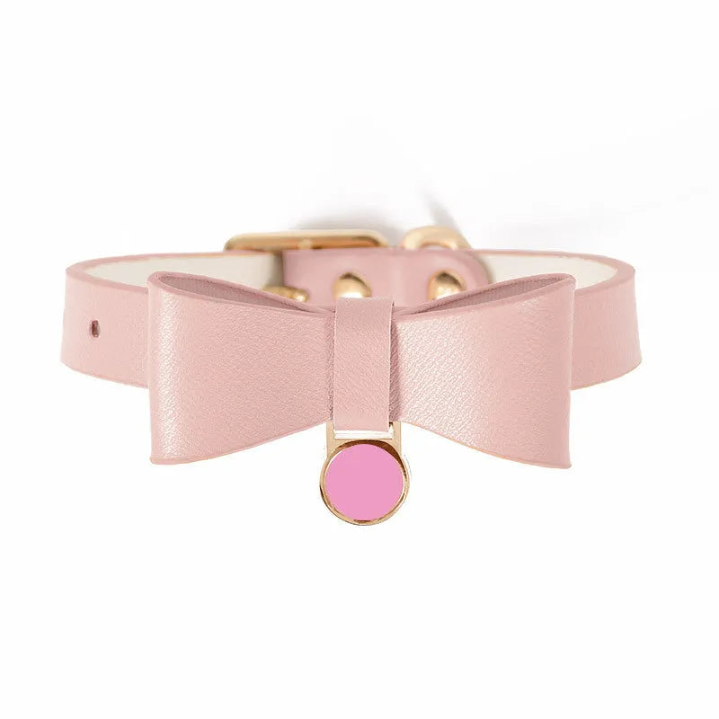 Adjustable brown leather cat collar with a metal buckle on a flat surface.