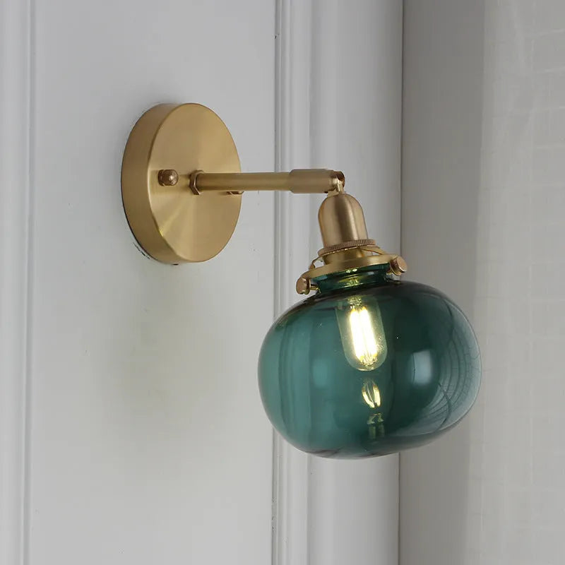 Creative pumpkin-shaped glass wall lamp in blue and transparent glass finishes for living room or bedroom.