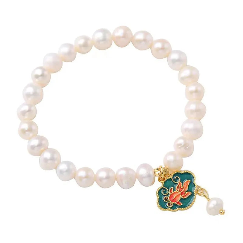 White vintage baroque bracelet with a freshwater pearl and goldfish lotus pendant.