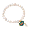 White vintage baroque bracelet with a freshwater pearl and goldfish lotus pendant.
