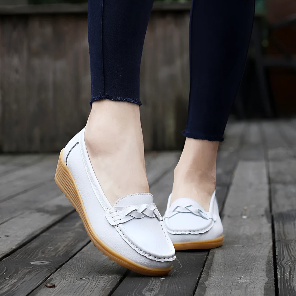 Women's cowhide Gommino soft bottom wedge heels in round toe style with genuine leather upper on display