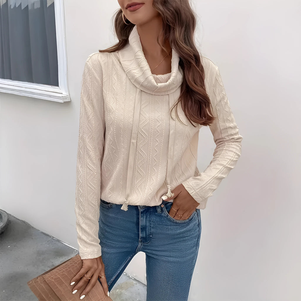 Apricot coloured long sleeve hooded pullover sweater on a hanger, showing the drawstring and solid colour.