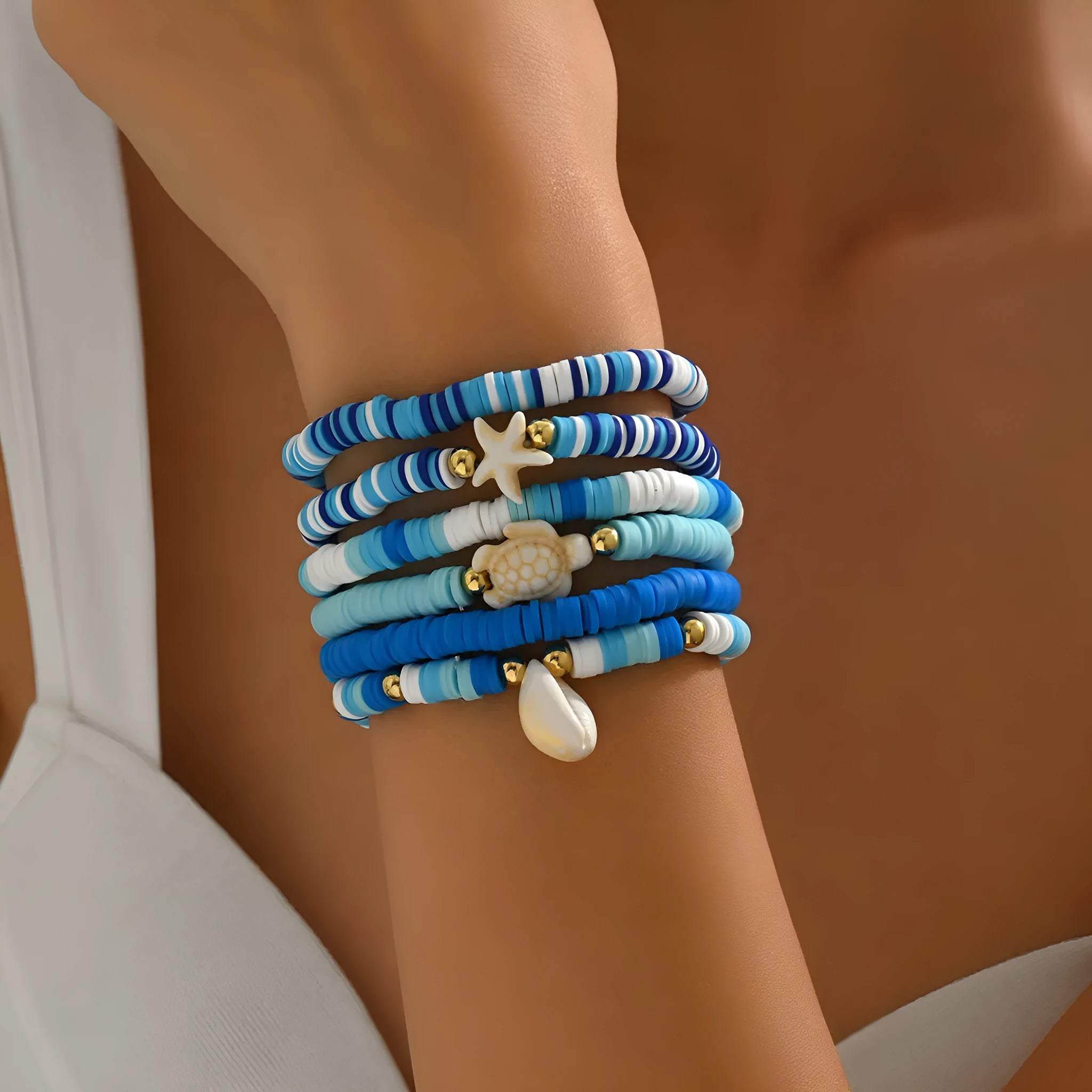 Six Bohemian blue polymer clay bracelets with geometric shell designs arranged as a set
