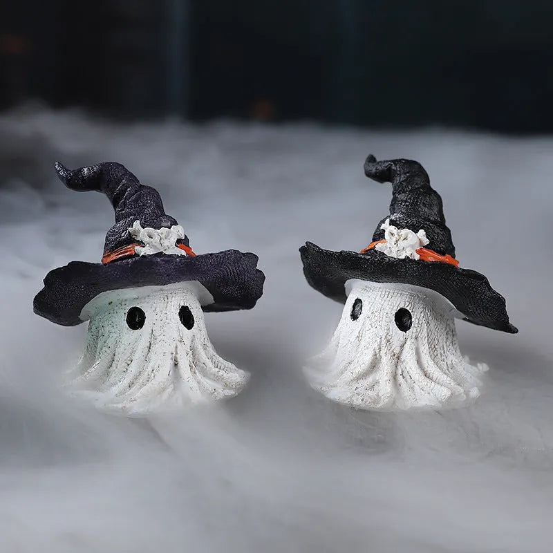 Close-up of a detailed black and a purple resin wizard hat ornament for holiday decoration.