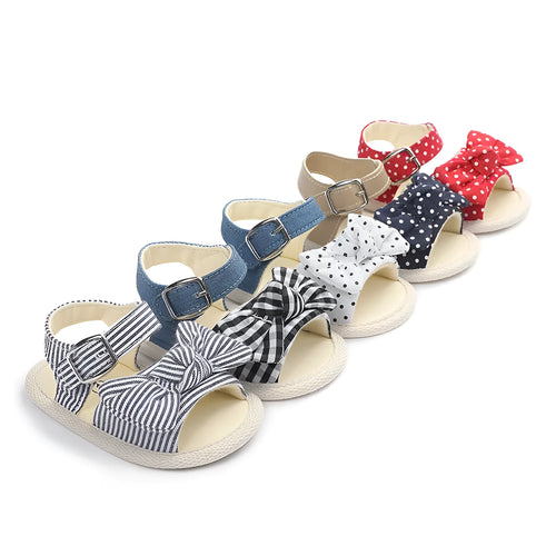 White and black Velcro baby toddler shoes for ages 0-18 months, showing low tube height design.