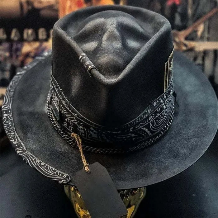 Handmade black and white skull print pointed witch hat on a wooden surface