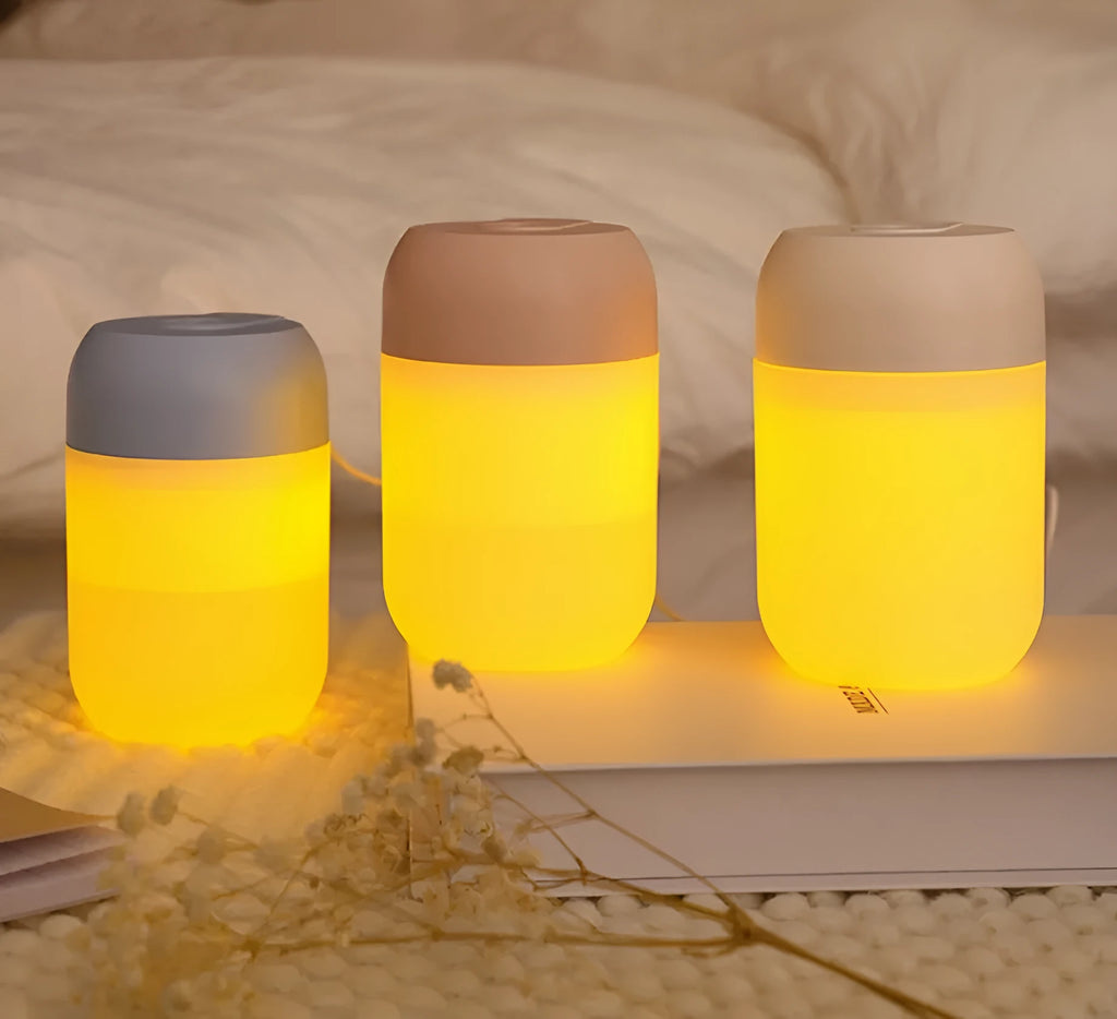 White cylindrical USB mini humidifier with mist output and charging cable