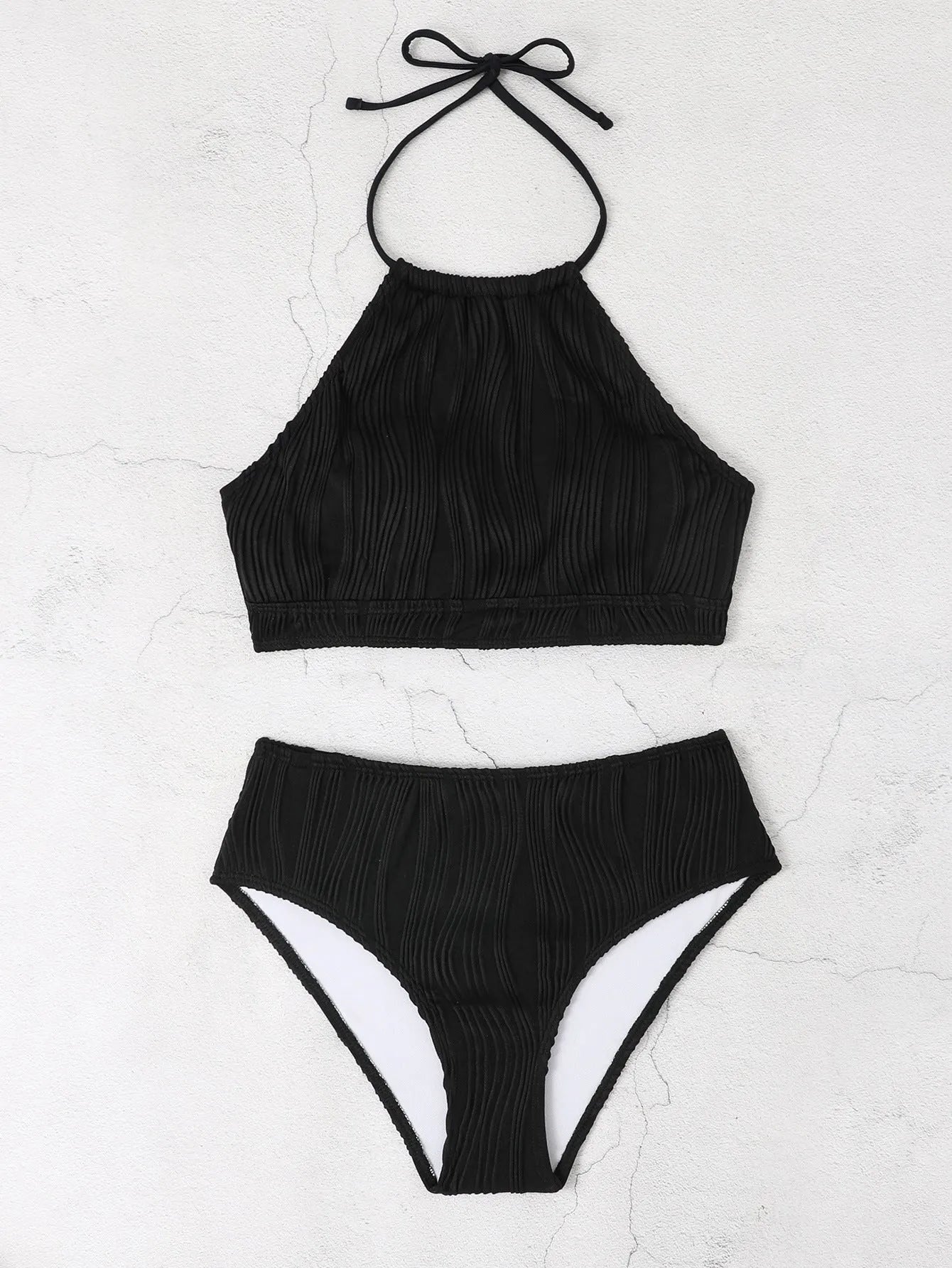 Women's high-waist apron-style conservative two-piece swimsuit in a solid colour.