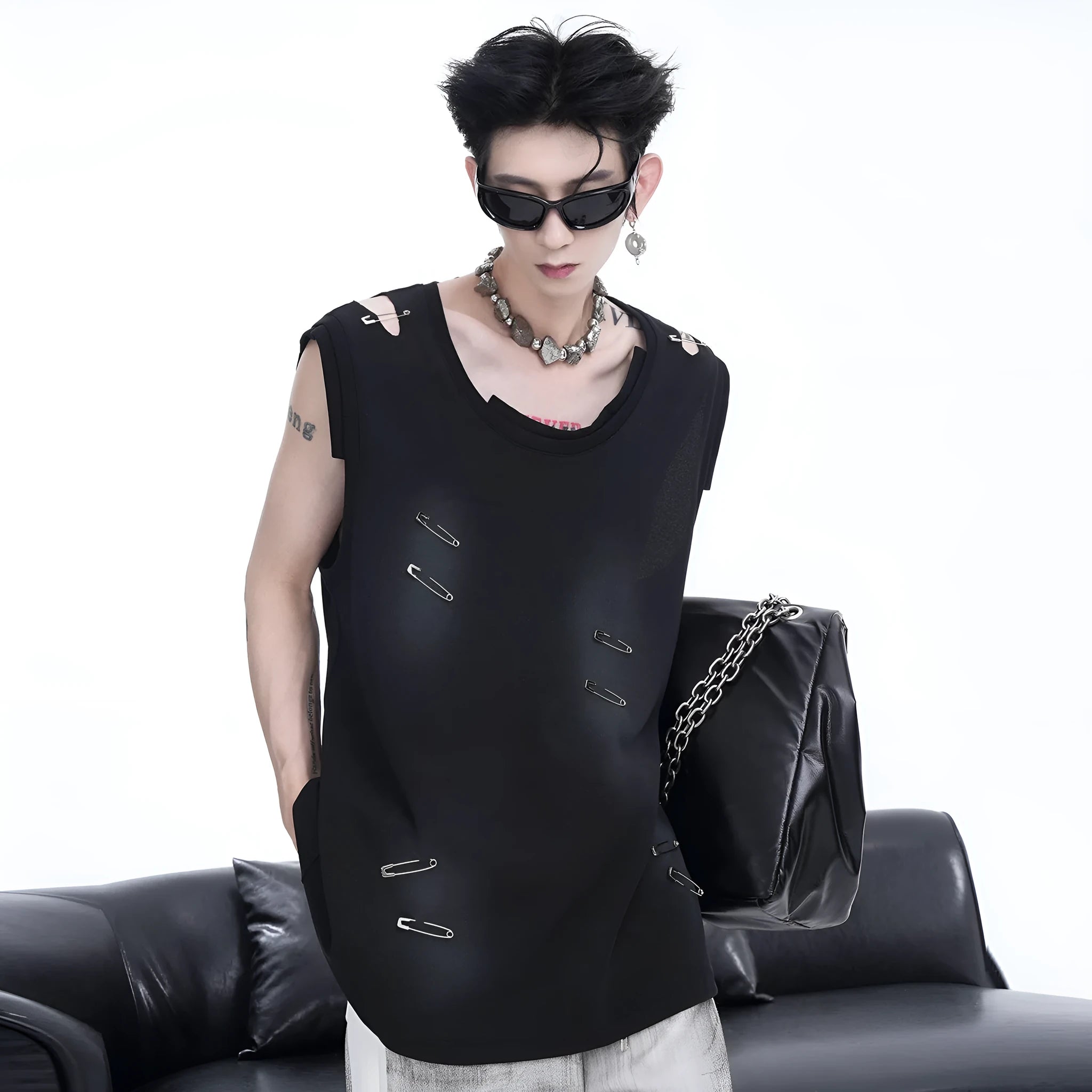 Men's black sleeveless vest waistcoat with ripped and irregular cutting detail on a mannequin.