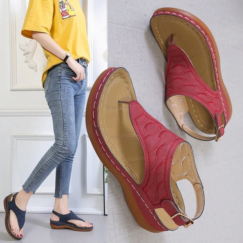 Women's black casual wedge heel sandals with an adjustable buckle strap on ankle.