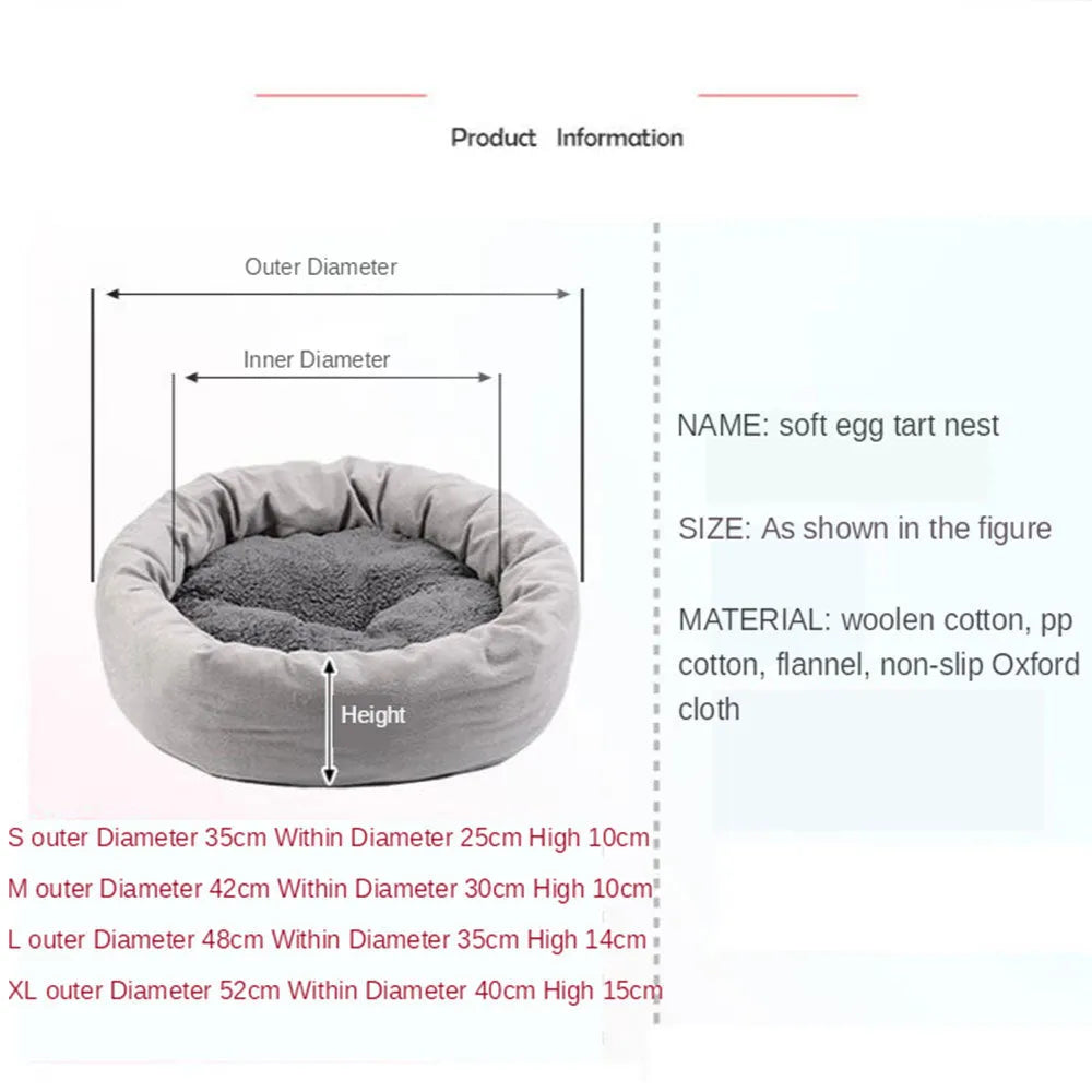 Grey round plush pet bed with pillow for small dogs and cats on a wood floor.