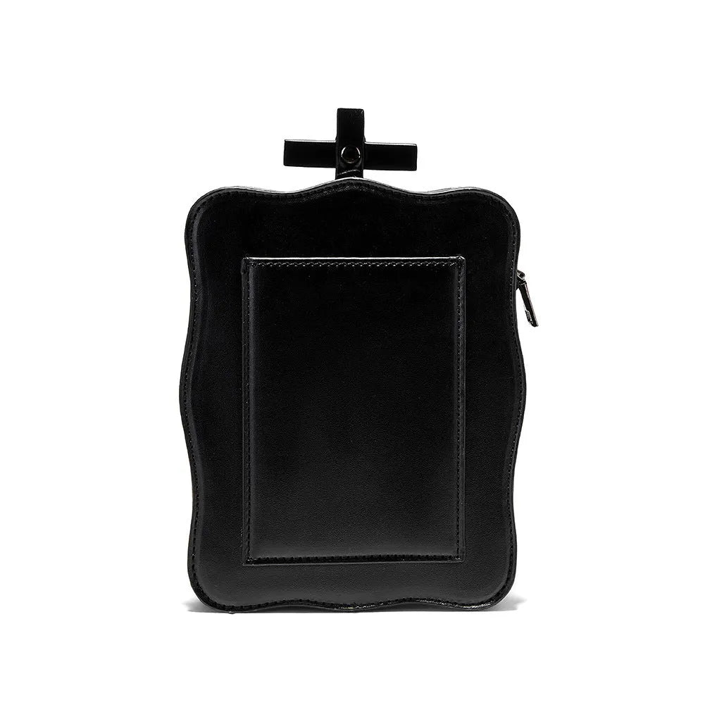 Black vertical square PU leather crossbody bag with embossed skull design, stitching, rivets, and a chain strap.